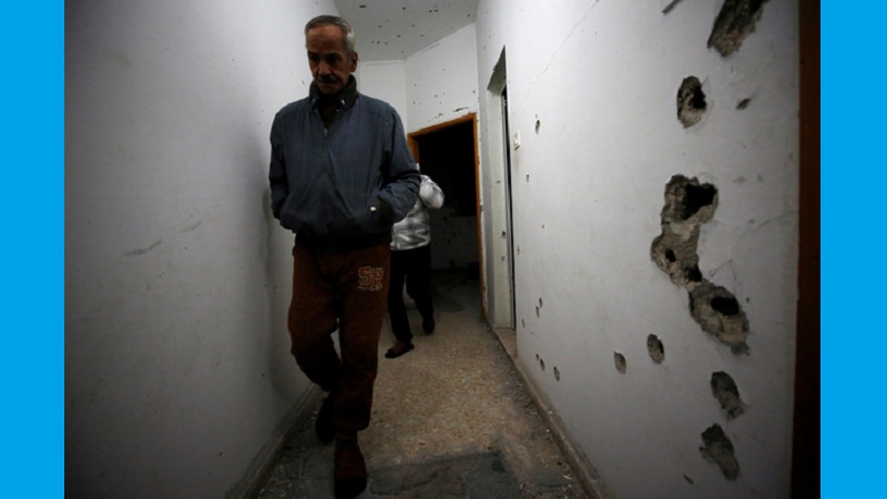 Man walks in a damaged house where a Palestinian gunman was killed by Israeli forces near Nablus in the Israeli-occupied West Bank 1.jpg